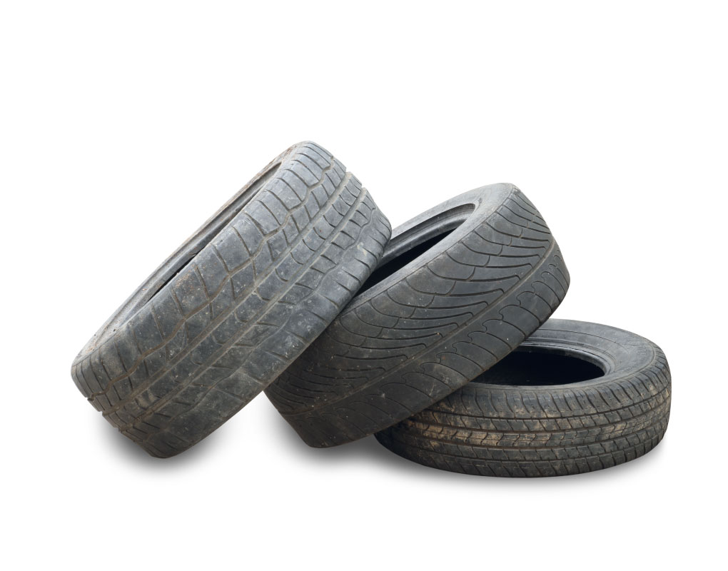 Three used tires piles on top of each other. 