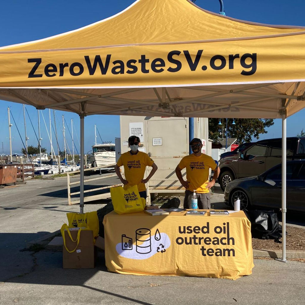 Used Oil Outreach Team tent and table at a marina dock